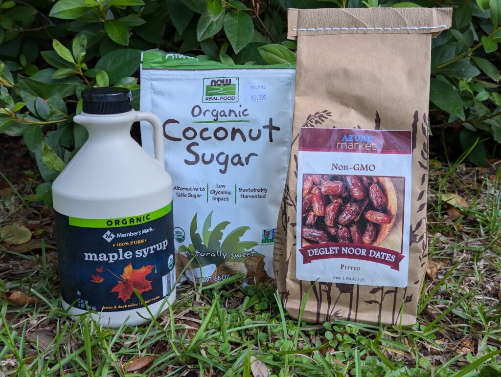 Healthy sugar alternatives, including organic maple syrup, organic coconut sugar, and pitted dates