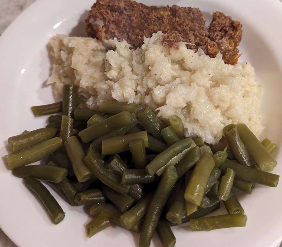 A perfect plate of food with half green beans, one-fourth mashed cauliflower, and one-fourth meatloaf