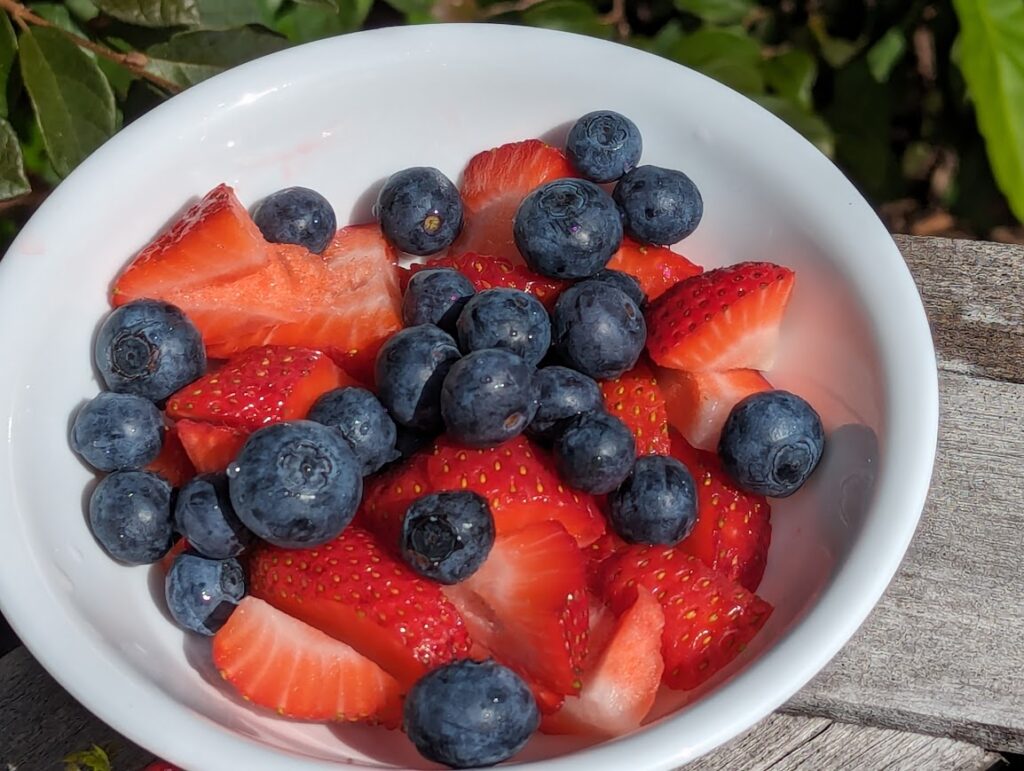 A perfect whole food snack: bowl of fresh strawberries and blueberries