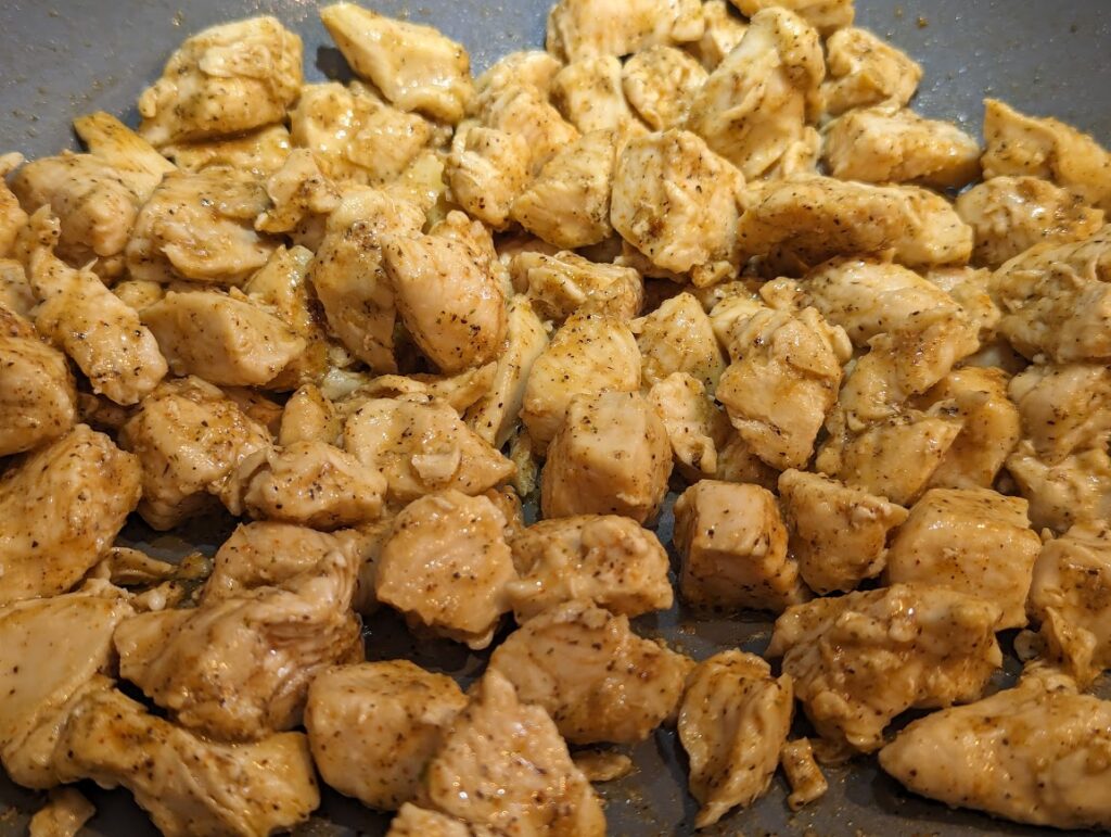 Up close view of seasoned sauted chicken in pan