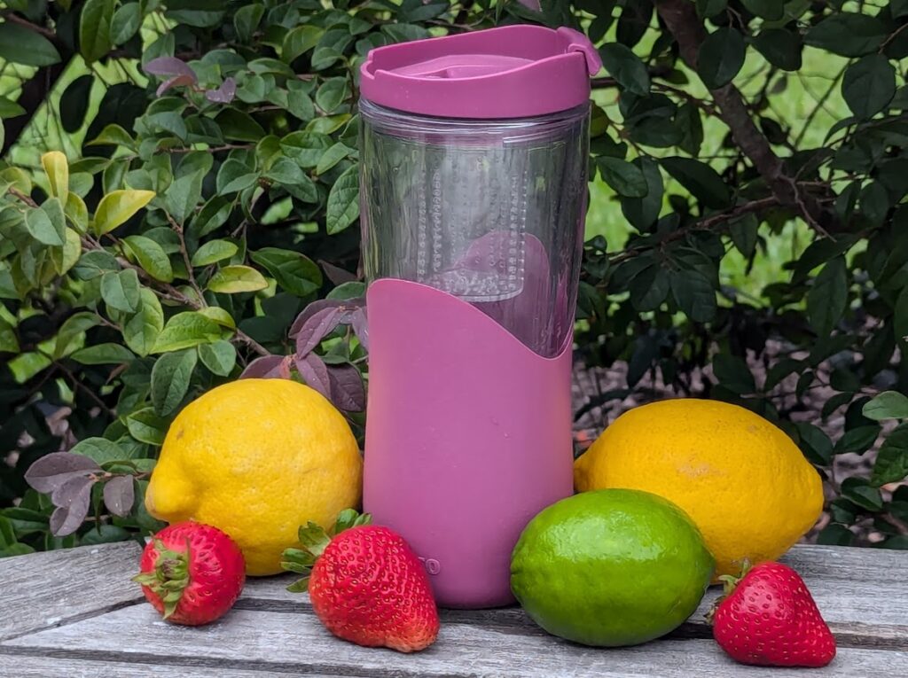 Tips to drink more water: use an infuser water bottle with lemons, strawberries, and lime