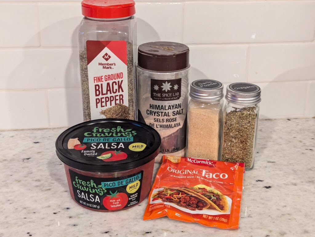 Ingredients for Instant Pot Chicken Recipe including pepper, salt, garlic powder, oregano, and fresh salsa