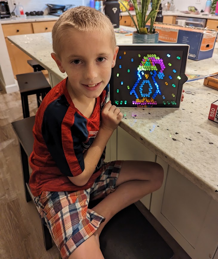 Child with Lite Brite making penguin