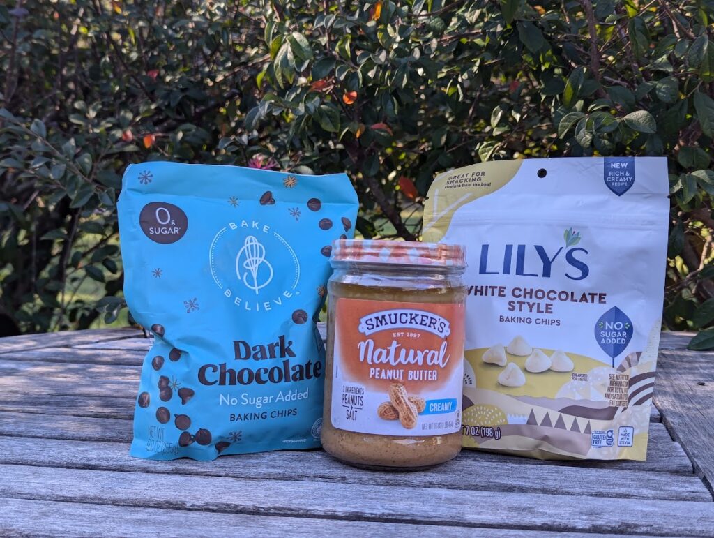 Ingredients for Healthy Peanut Butter Bark, including Bake Believe Chocolate Chips, Smucker's Natural Peanut Butter, and Lily's White Chocolate Chips