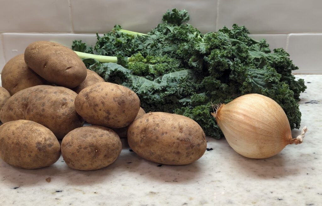 Potatoes, onion, and kale ready to go in recipe