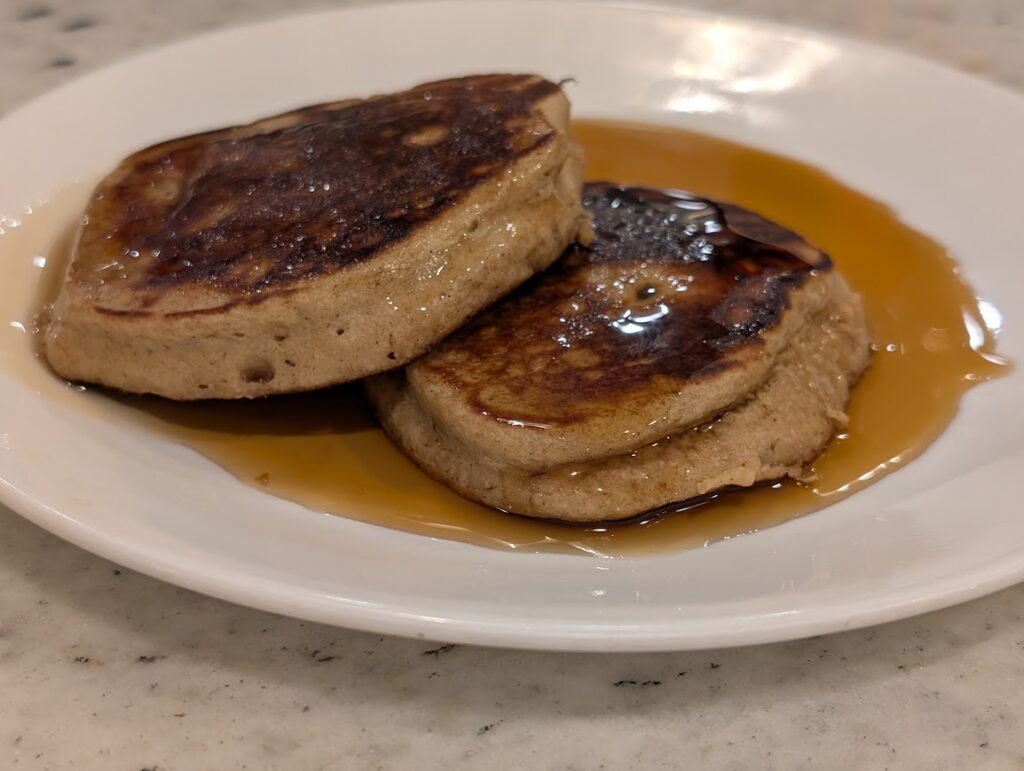 Cinnamon Banana Oat Pancakes with Maple Syrup on Top