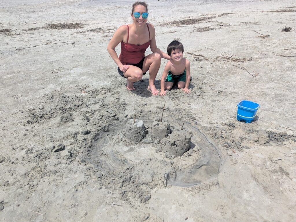 Jessica and Aiden building a sand castle at the beach